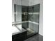 A modern bathroom with a walk-in shower featuring a glass enclosure and stylish tile at 4046 Creekview Ridge Dr, Buford, GA 30518