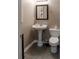 Cozy half bathroom featuring a pedestal sink, toilet, and a decorative mirror at 4046 Creekview Ridge Dr, Buford, GA 30518
