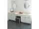 A bright bathroom with dual vanity sinks, a makeup area, and gray tile flooring at 4046 Creekview Ridge Dr, Buford, GA 30518