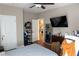 Bedroom with dark wood floors, a ceiling fan, a large wall mirror, and plenty of storage at 4046 Creekview Ridge Dr, Buford, GA 30518