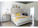 A bright bedroom with a tufted headboard, modern nightstands, and an ensuite bathroom at 4046 Creekview Ridge Dr, Buford, GA 30518