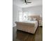 Spacious bedroom with a large upholstered bed and hardwood flooring at 4046 Creekview Ridge Dr, Buford, GA 30518