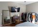 Bedroom with hard wood floors and decor; features large mirror, ceiling fan, dresser and TV at 4046 Creekview Ridge Dr, Buford, GA 30518