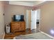 Bedroom featuring a wood dresser, television, and comfortable looking bed at 4046 Creekview Ridge Dr, Buford, GA 30518
