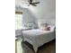Comfortable bedroom with sloped ceiling, work space, plush bedding, and hardwood floors at 4046 Creekview Ridge Dr, Buford, GA 30518