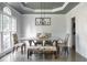 Bright dining room with large windows, stylish chairs, and modern chandelier at 4046 Creekview Ridge Dr, Buford, GA 30518