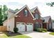 Charming two-story brick home with a two-car garage, manicured lawn, and beautiful landscaping at 4046 Creekview Ridge Dr, Buford, GA 30518