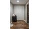 Hallway featuring a closet with white doors and dark wood-look flooring at 4046 Creekview Ridge Dr, Buford, GA 30518