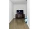 Bright living room with wood floors, TV, and sleek media cabinet at 4046 Creekview Ridge Dr, Buford, GA 30518