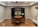 Spacious living area featuring dark media center, wooden table and flooring at 4046 Creekview Ridge Dr, Buford, GA 30518