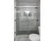Modern shower enclosed with glass doors, patterned tile accents, and chrome fixtures at 4046 Creekview Ridge Dr, Buford, GA 30518