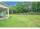 Spacious backyard featuring lush green grass, mature trees and a privacy fence at 4824 Se Highway 20, Conyers, GA 30013