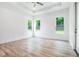 Bright primary bedroom with tray ceiling, three windows and wood-look flooring at 4824 Se Highway 20, Conyers, GA 30013