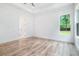 Bright bedroom with hardwood floors, tray ceiling, and a large window view at 4824 Se Highway 20, Conyers, GA 30013