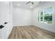 Sunlit bedroom features laminate floors, a ceiling fan, and large window at 4824 Se Highway 20, Conyers, GA 30013