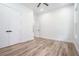 Open bedroom with laminate wood flooring, and a window providing natural light at 4824 Se Highway 20, Conyers, GA 30013