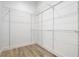 Walk-in closet with metal shelving and wood look floors at 4824 Se Highway 20, Conyers, GA 30013