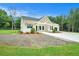 Eye-catching single-Gathering home showcasing a charming modern farmhouse design with a spacious front yard at 4824 Se Highway 20, Conyers, GA 30013