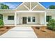 Modern farmhouse style home featuring a welcoming front entrance with a covered porch and wood double doors at 4824 Se Highway 20, Conyers, GA 30013