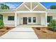 Inviting front porch with modern farmhouse design details, decorative columns, and a welcoming entrance at 4824 Se Highway 20, Conyers, GA 30013