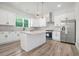 Modern kitchen featuring white cabinets, stainless steel appliances, and a center island with seating at 4824 Se Highway 20, Conyers, GA 30013