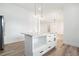 Kitchen featuring island with storage, modern lighting and stainless steel refrigerator at 4824 Se Highway 20, Conyers, GA 30013
