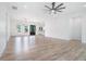 Light-filled living room with hardwood flooring, ceiling fan, recessed lighting, and open-concept layout at 4824 Se Highway 20, Conyers, GA 30013