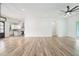 Bright living room featuring hardwood floors, recessed lighting, and an open layout leading into the kitchen at 4824 Se Highway 20, Conyers, GA 30013