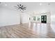 Open-concept living room showcasing hardwood floors, high ceilings, a ceiling fan, and abundant natural light at 4824 Se Highway 20, Conyers, GA 30013