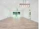 Modern living room showcasing hardwood floors, recessed lighting, and contemporary pendant light fixtures at 4824 Se Highway 20, Conyers, GA 30013