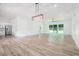 Bright and spacious living room featuring an open floor plan and large sliding glass doors to the backyard at 4824 Se Highway 20, Conyers, GA 30013