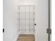 Pantry area with white wire rack shelving and laminate flooring at 4824 Se Highway 20, Conyers, GA 30013