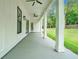 Covered porch with ceiling fans and views of the landscaped backyard at 4824 Se Highway 20, Conyers, GA 30013