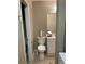 A cozy bathroom featuring a toilet, sink, mirror, and neutral tones at 5570 Chemin De Vie, Atlanta, GA 30342