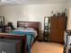 Bedroom featuring a large bed, neutral walls, and wood furniture at 5570 Chemin De Vie, Atlanta, GA 30342