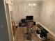 Home gym featuring a chandelier, weights, shelving, television, barstool and exercise equipment at 5570 Chemin De Vie, Atlanta, GA 30342