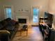 Inviting living room with wood floors, fireplace, sofa, and access to the yard at 5570 Chemin De Vie, Atlanta, GA 30342