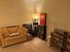 Cozy living room with a light brown couch, shelving, and lamp at 5570 Chemin De Vie, Atlanta, GA 30342