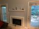 Living room featuring a fireplace and doors leading to the outdoor space at 5570 Chemin De Vie, Atlanta, GA 30342