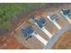 Aerial view of three homes showcasing dark shingles, fenced yards, and concrete driveways at 180 Eryn Ter, Covington, GA 30014