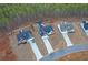 Aerial view of three houses featuring dark shingles, concrete driveways, and a treeline at 180 Eryn Ter, Covington, GA 30014
