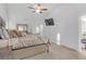 Spacious main bedroom with a plush bed, TV, and ensuite bathroom access at 180 Eryn Ter, Covington, GA 30014
