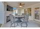 Outdoor living area featuring a fireplace, mounted TV, and seating around a fire pit table at 180 Eryn Ter, Covington, GA 30014