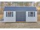 Exterior view of a shed with shutters, double doors, and a metal roof at 180 Eryn Ter, Covington, GA 30014
