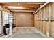 Unfinished basement with exposed studs and concrete floor, offering potential for customization at 230 Channings Lake Dr, Lawrenceville, GA 30043