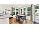 A bright dining area with a wood table, hardwood floors and view of the outdoor deck at 230 Channings Lake Dr, Lawrenceville, GA 30043