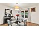 Elegant dining room with a glass table, modern chairs, and stylish light fixture at 230 Channings Lake Dr, Lawrenceville, GA 30043