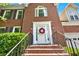 Close up of the brick steps and welcoming front door adorned with a wreath at 230 Channings Lake Dr, Lawrenceville, GA 30043