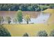 Picturesque lake view with trees and well maintained grassy shoreline at 230 Channings Lake Dr, Lawrenceville, GA 30043