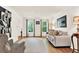 A well-lit living room with hardwood floors, neutral paint and two windows with natural lighting at 230 Channings Lake Dr, Lawrenceville, GA 30043